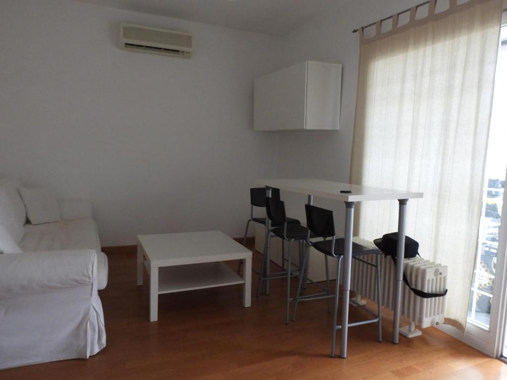 a living room with a table and chairs and a couch at The Right Place 4U Roma Monteverde Al Palazzetto Apartment with Terrace&Garage in Rome