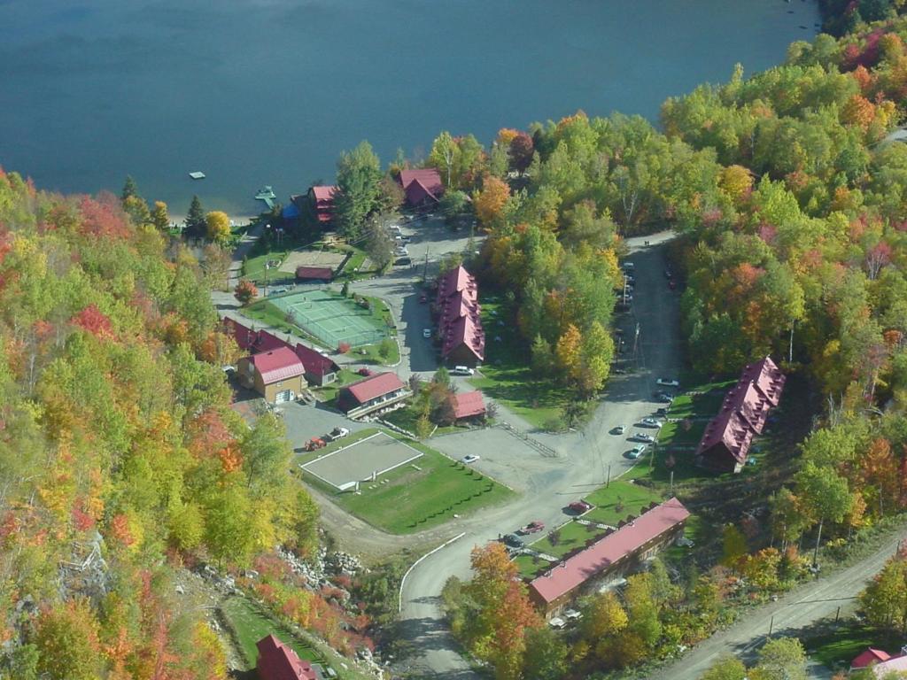 an aerial view of a house on a hill with trees at Auberge du Lac Morency in Saint-Hippolyte