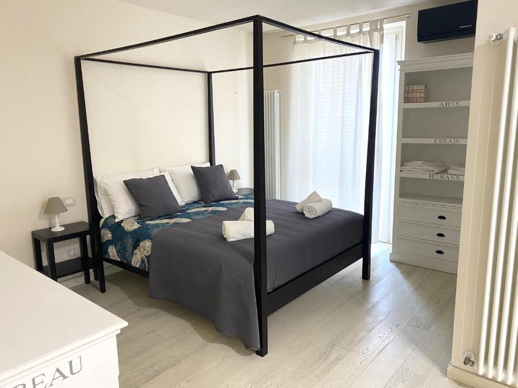 a bedroom with a canopy bed in a room at Front Beach Deluxe Apartment - with access to beach club in Viareggio