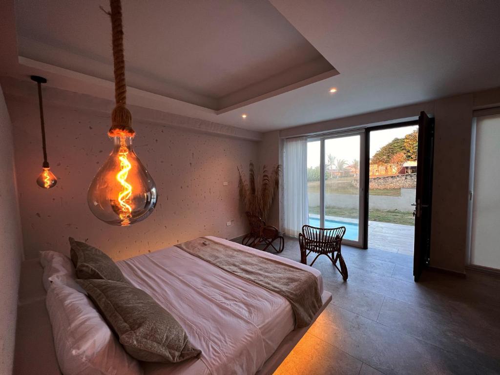 a bedroom with a bed and a large window at Casa Alcatraz in Puerto Colombia