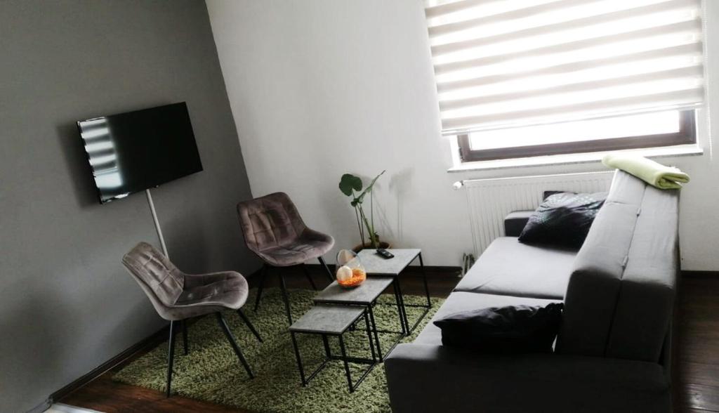 a living room with a couch and two chairs at Modern Apartment 2 in Brčko