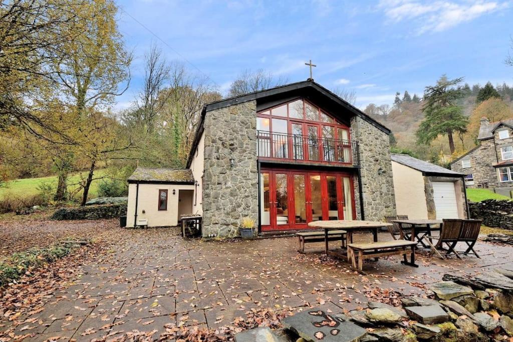 a large stone building with a picnic table in front of it at Betws Y Coed Serviced Holiday Home in Betws-y-coed