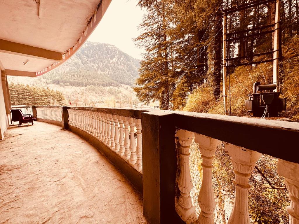 a balcony of a house with a view of a mountain at Hotel Kanchan Classic Manali in Manāli