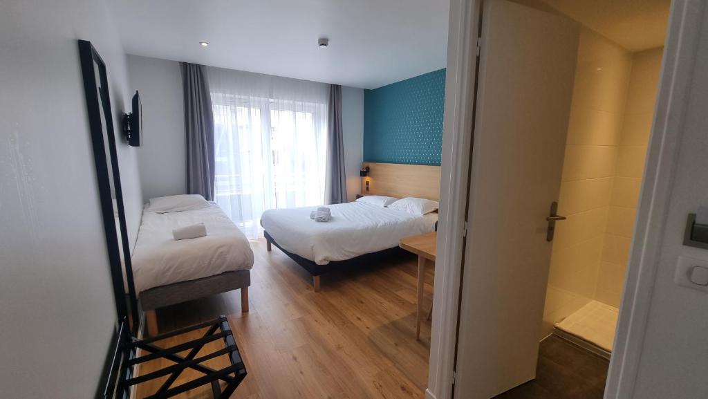 Postel nebo postele na pokoji v ubytování Oskar Hotel