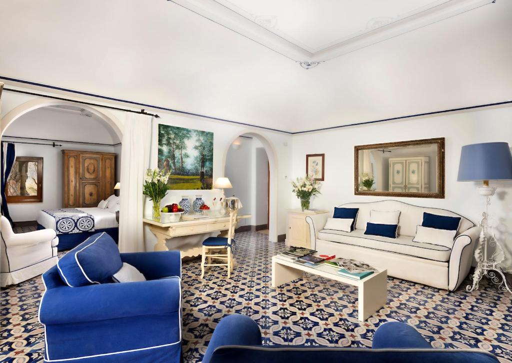 a living room with a couch and a table at Hotel Villa Cimbrone in Ravello