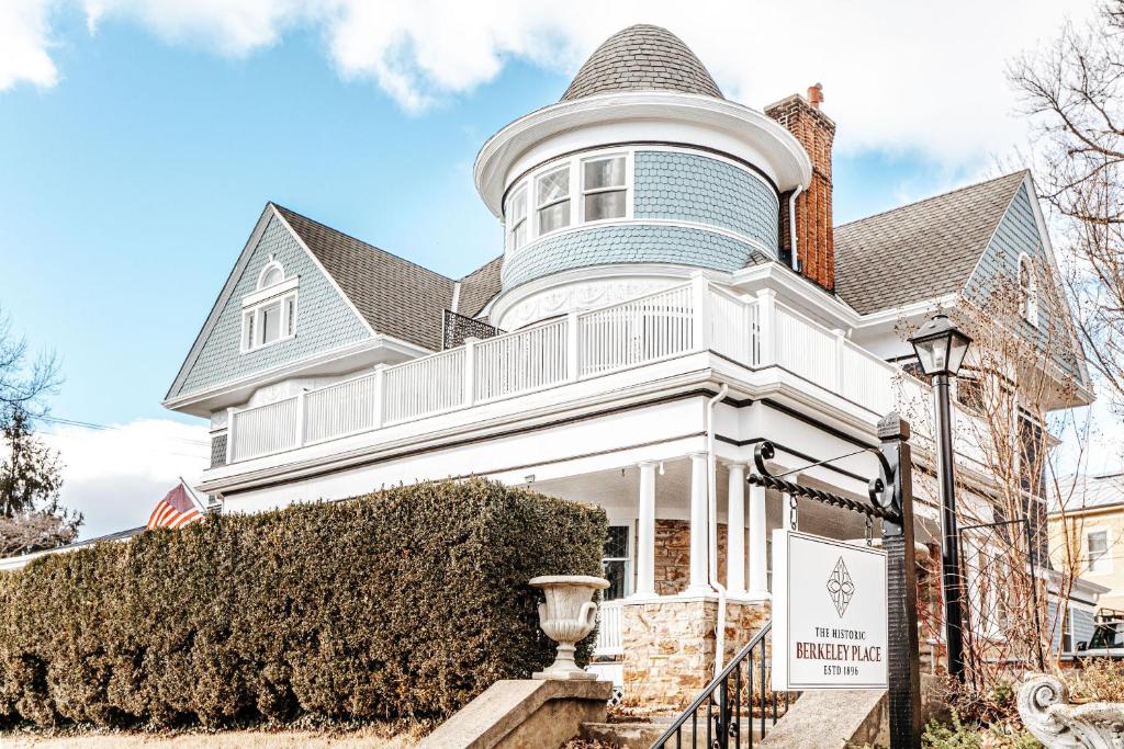 Una casa blanca con una torreta encima. en The Historic Berkeley Place en Staunton