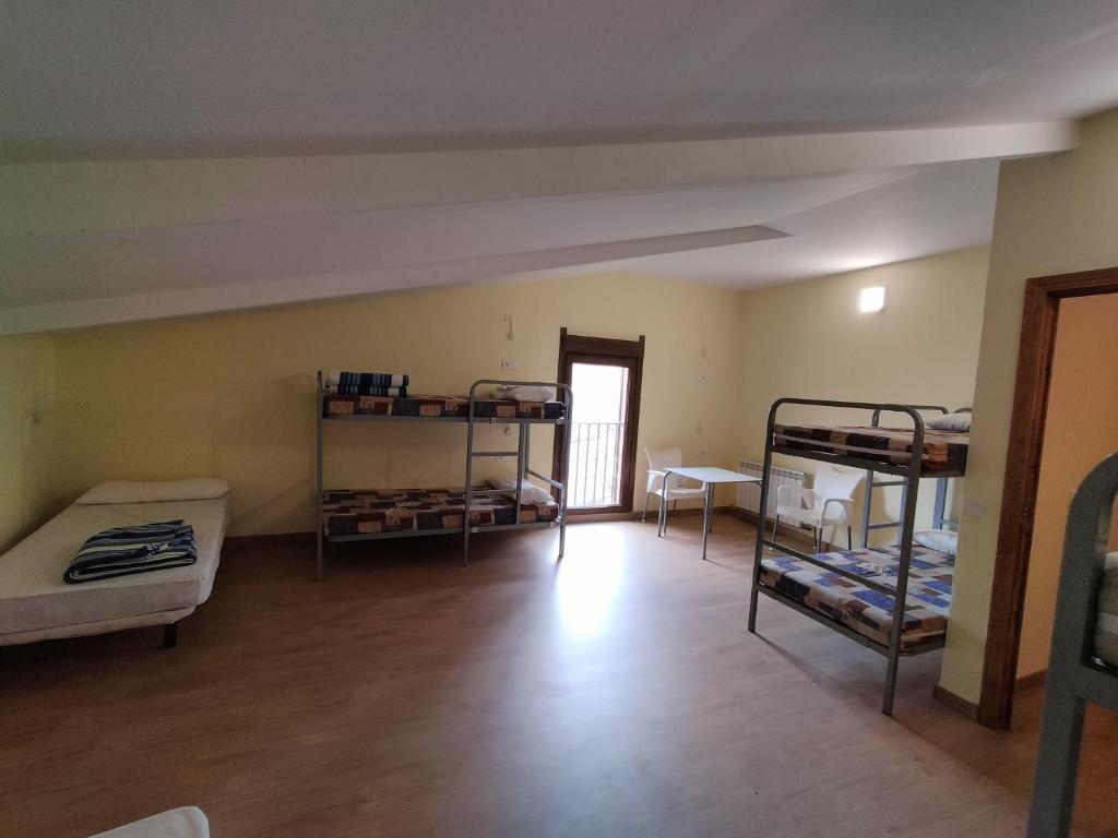 Postel nebo postele na pokoji v ubytování Albergue Don Camino