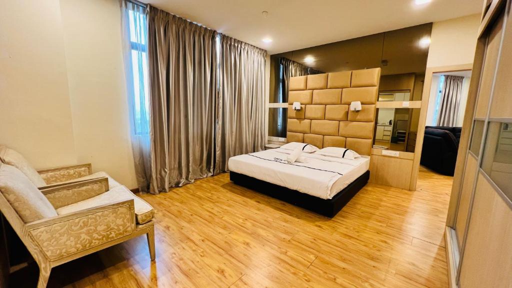 a hotel room with a bed and a chair at Seeds Hotel Cheras Taman Bukit Segar in Cheras