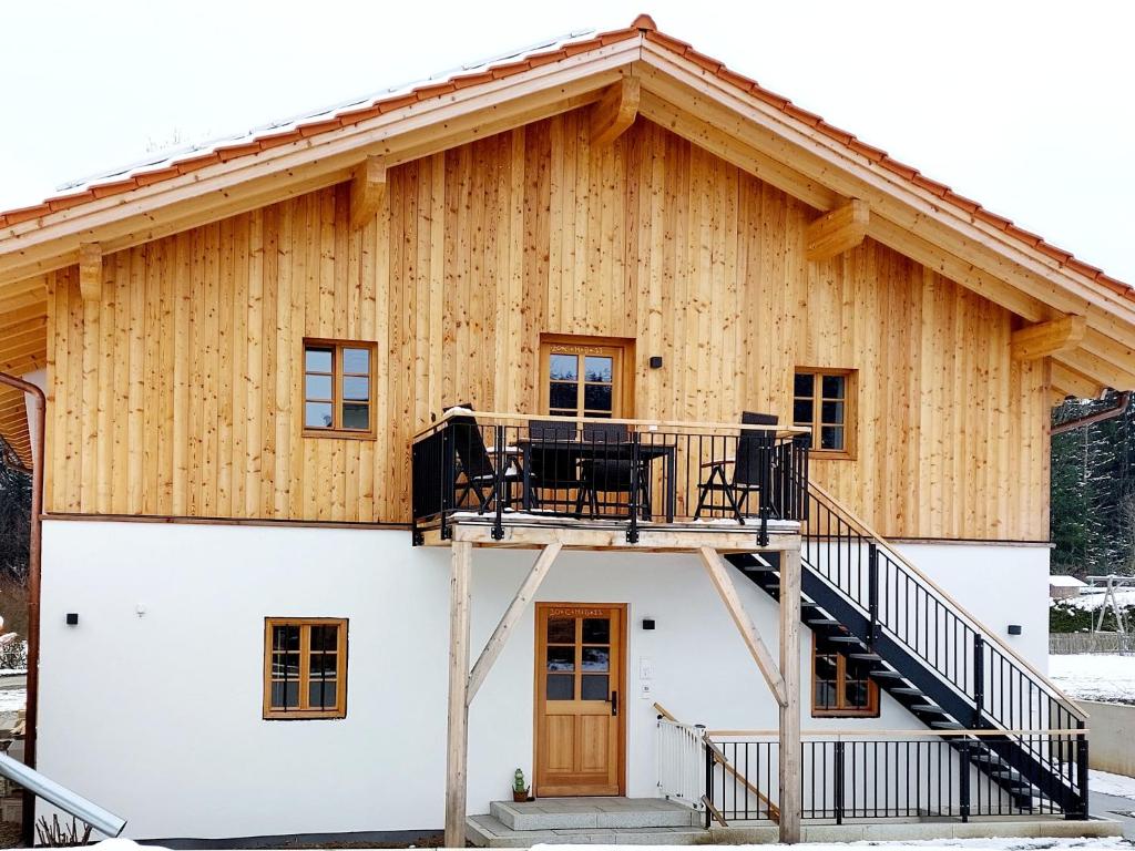 a house with a deck on the side of it at Ferienwohnungen Koller in Bad Aibling