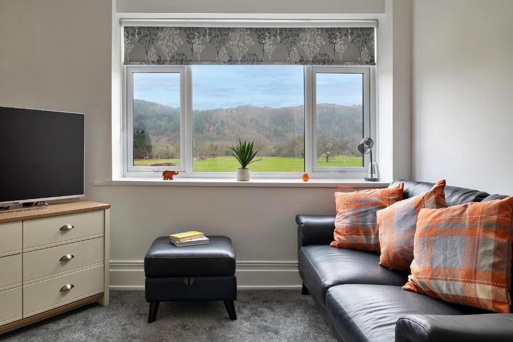a living room with a couch and a window at Finest Retreats - Smithfields in Llanrwst