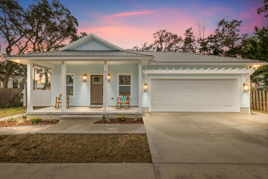 a white house with a garage at Brand New Entire Home close to beach in St. Augustine