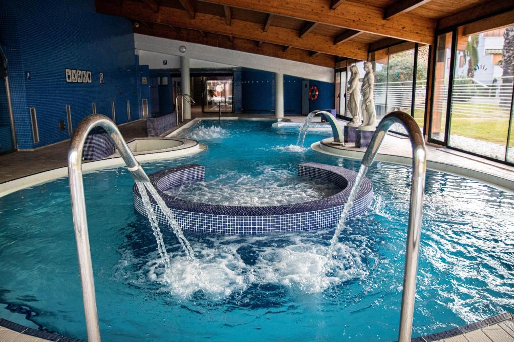 a large swimming pool with two fountains at Estival Park Silmar in La Pineda