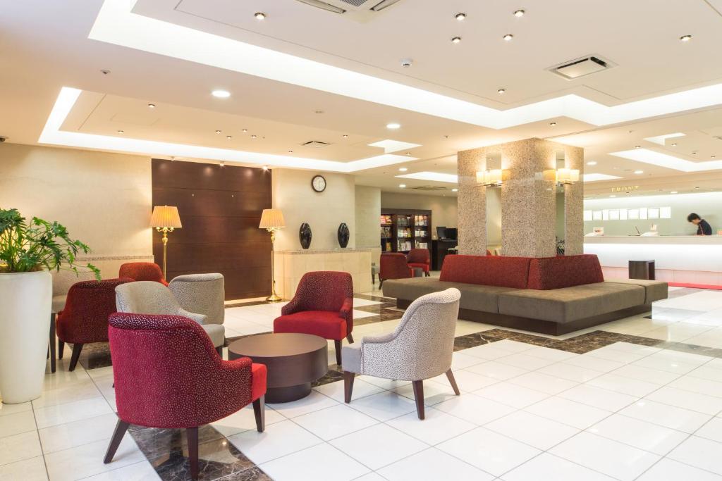 a lobby of a hotel with chairs and a waiting room at Hotel Hokke Club Sapporo in Sapporo