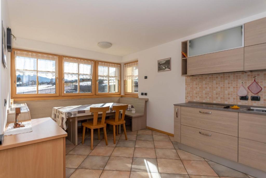 a kitchen with a table and chairs in it at Casa Freina in Vigo di Fassa