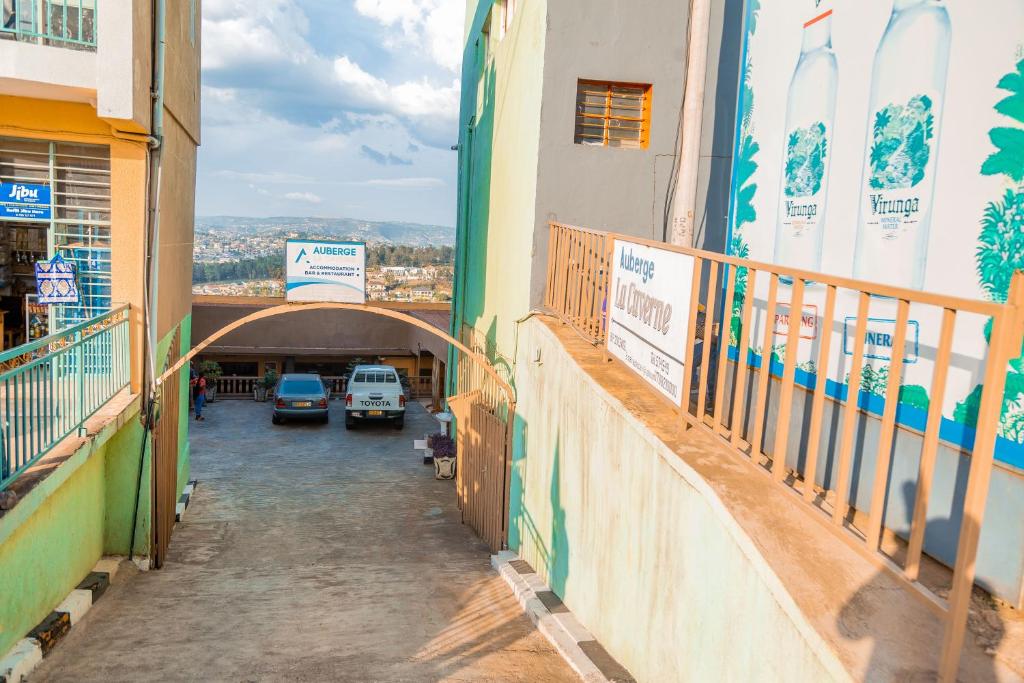 an alley with surfboards on the side of a building at Auberge La Caverne in Kigali