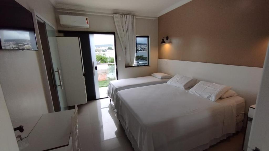 Postel nebo postele na pokoji v ubytování Faixa Hotel