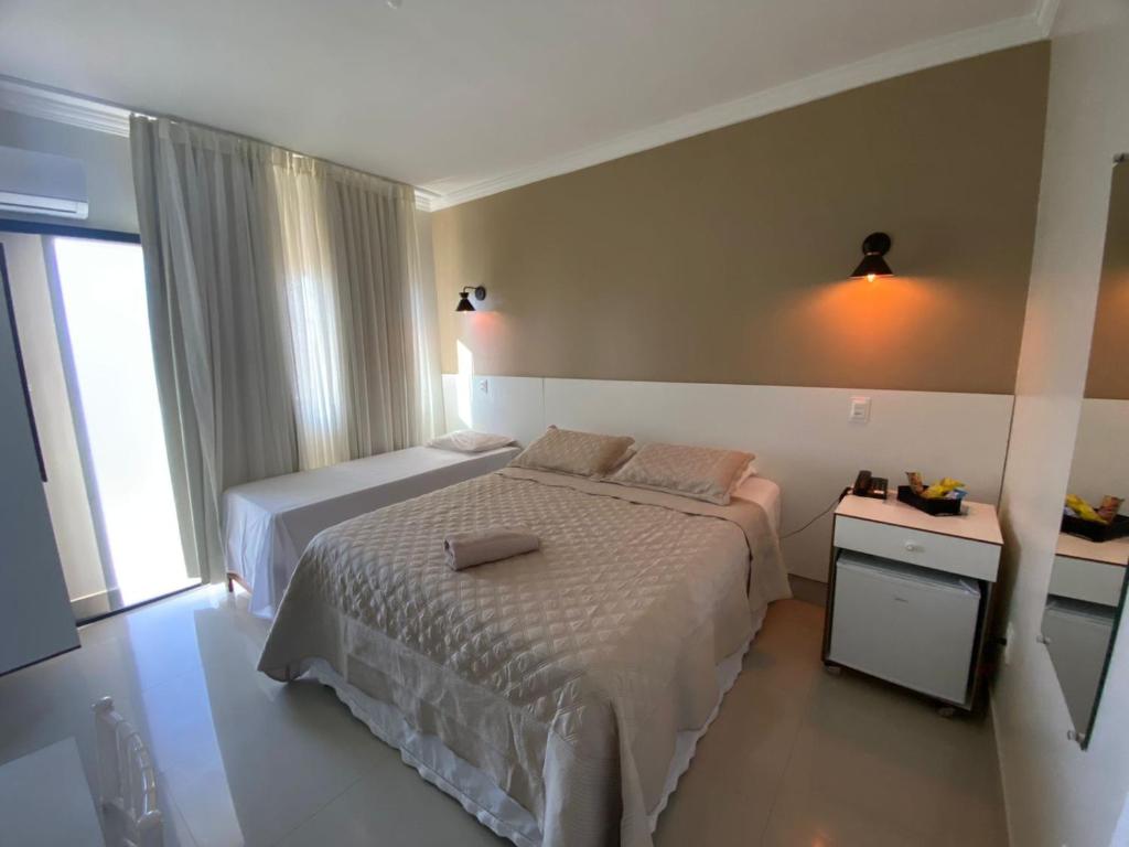 Postel nebo postele na pokoji v ubytování Faixa Hotel