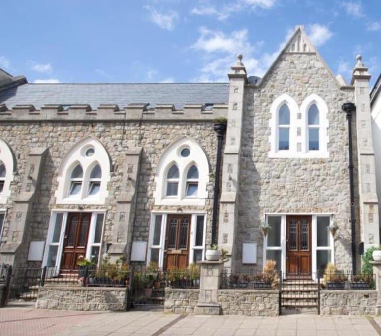 a large stone building with white windows and doors at Chapel Theatre House in Sandgate