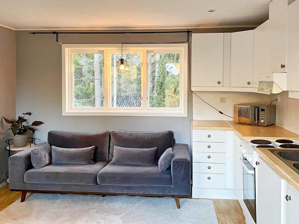 a living room with a couch in a kitchen at Holiday home INGARÖ VI in Lillängsdal