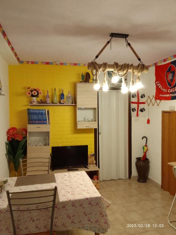 a dining room with a table and a refrigerator at AL MARE, AL SOLE, SI', ma nella CASA DEL MINATORE in Buggerru