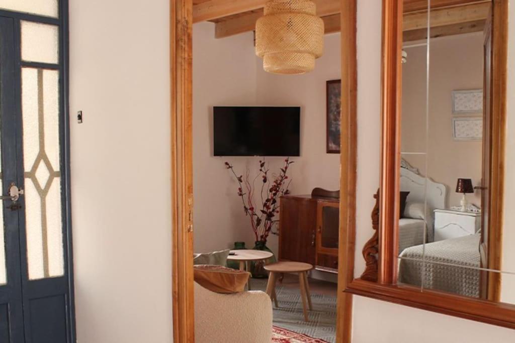 a room with a living room with a mirror at Casa Rural Tío Samuel 