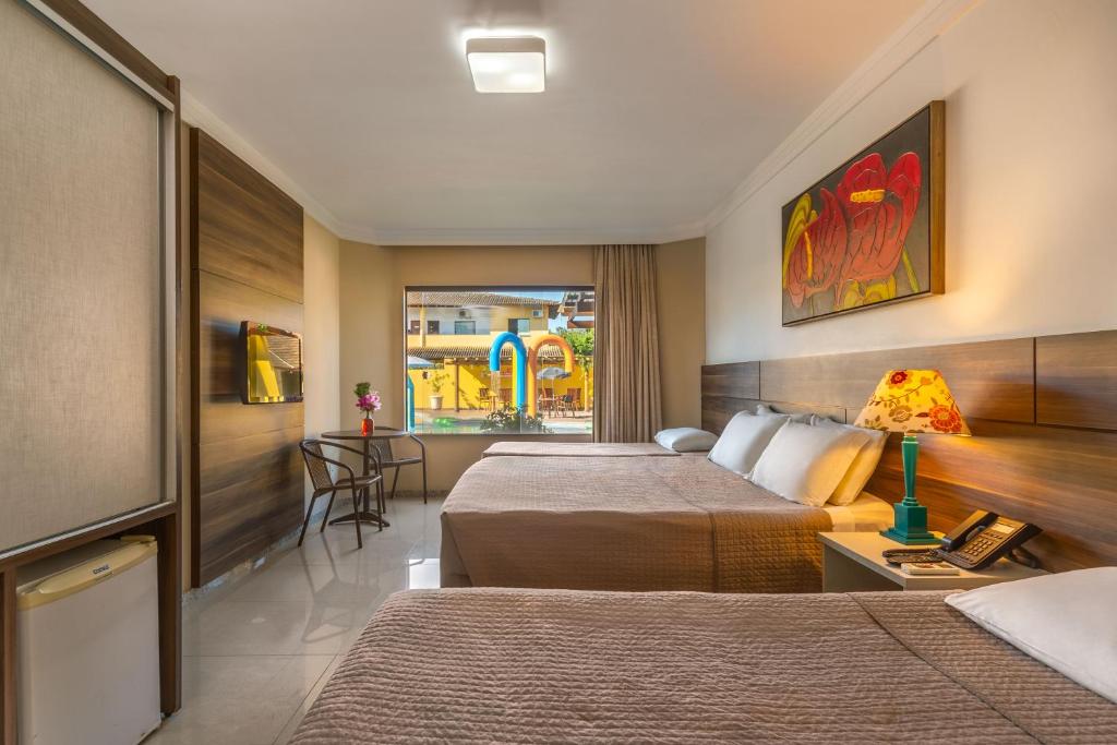 Postel nebo postele na pokoji v ubytování Transoceanico Praia Hotel