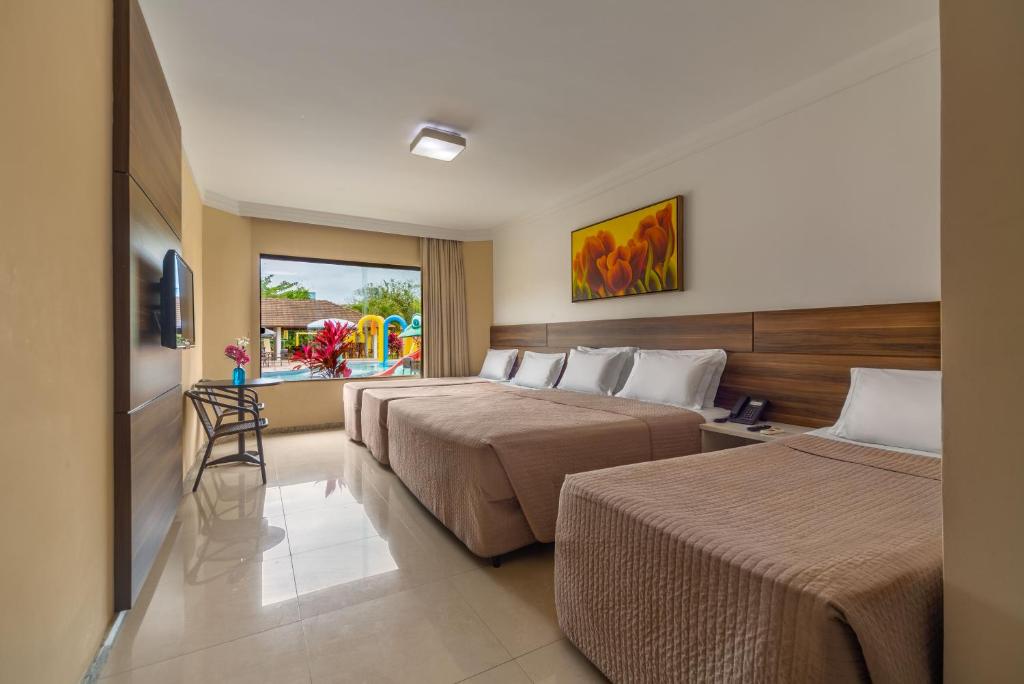 Postel nebo postele na pokoji v ubytování Transoceanico Praia Hotel