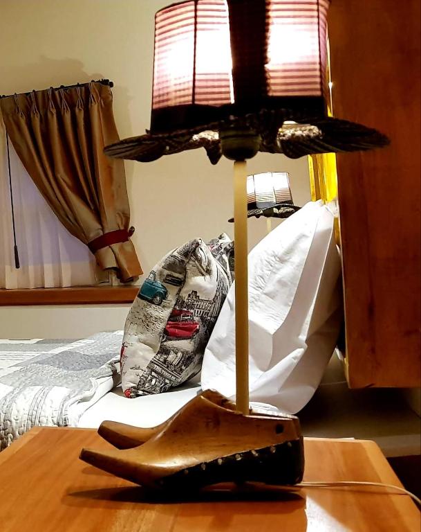 a lamp sitting on top of a table next to a bed at Old Town Quito Suites, Heritage Boutique Hotel, Where Every Detail Tells a Story in Quito