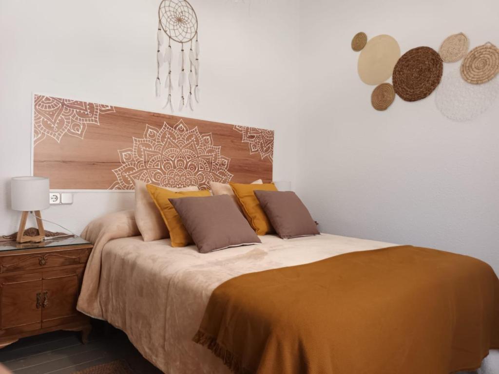 a bedroom with a large bed with a wooden headboard at Un tros de Sal. Casa Rural a Gerri de la Sal. in Gerri
