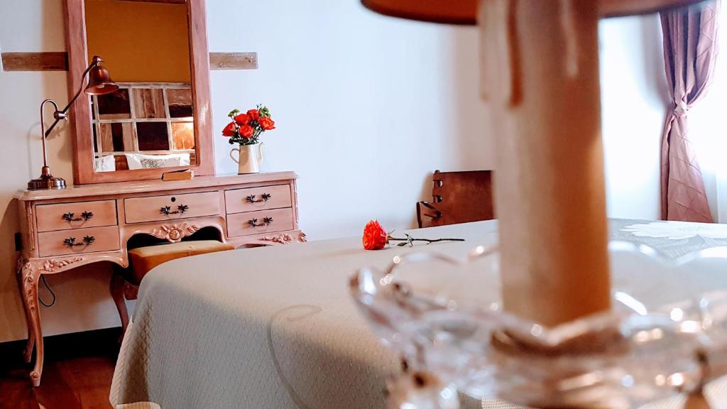 a bedroom with a table and a dresser with a mirror at Old Town Quito Suites, Heritage Boutique Hotel, Where Every Detail Tells a Story in Quito