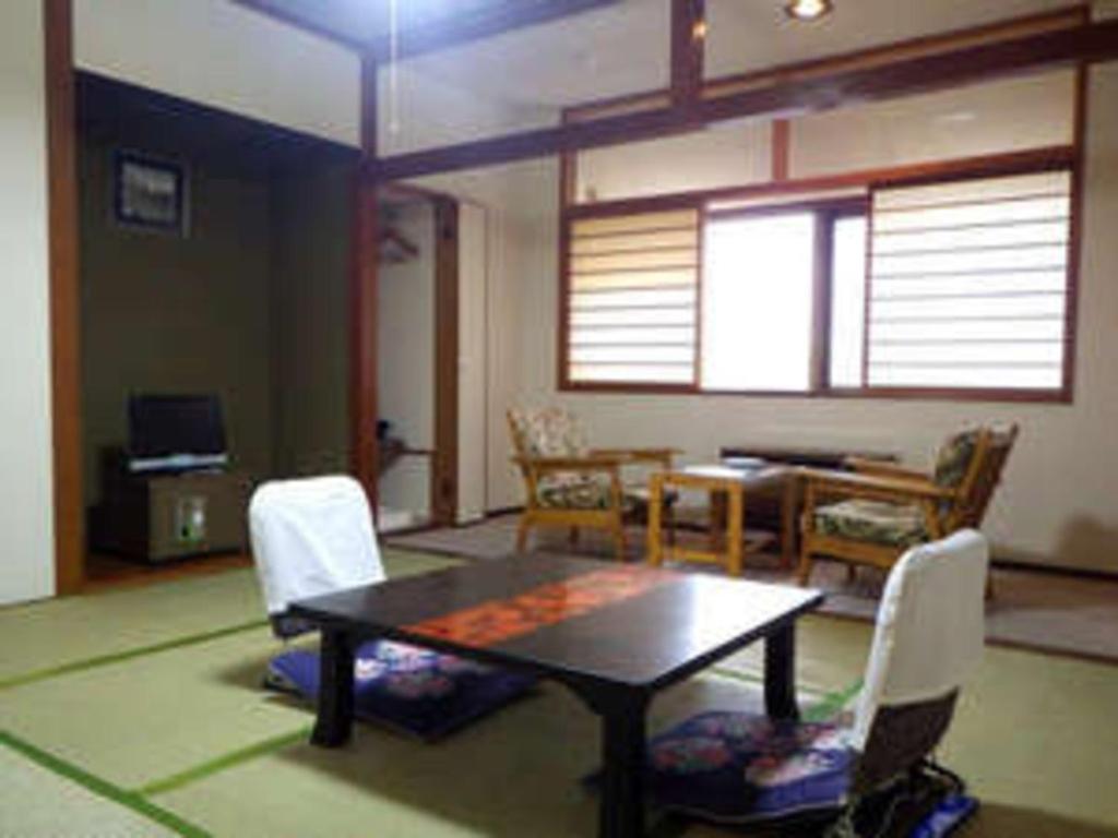 a room with a table and chairs and a dining room at Mashu Onsen Hotel Mashu - Vacation STAY 69295v in Teshikaga