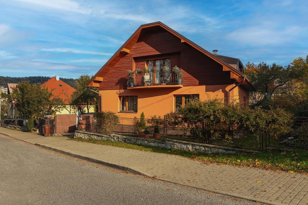 a house with a balcony on the side of a street at Apartmány Kašper in Levoča