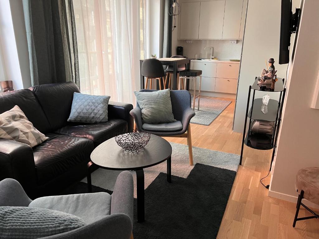 a living room with a couch and chairs and a table at Haga 1 bedroom Apartment in Stockholm