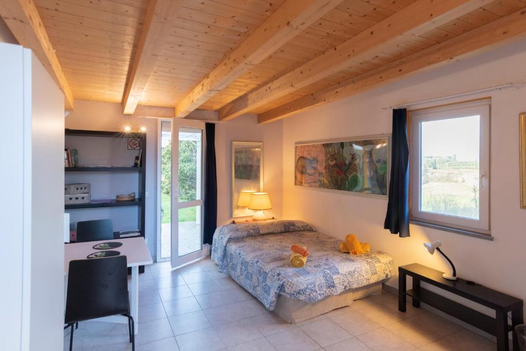 Postel nebo postele na pokoji v ubytování Agriturismo La Pineta