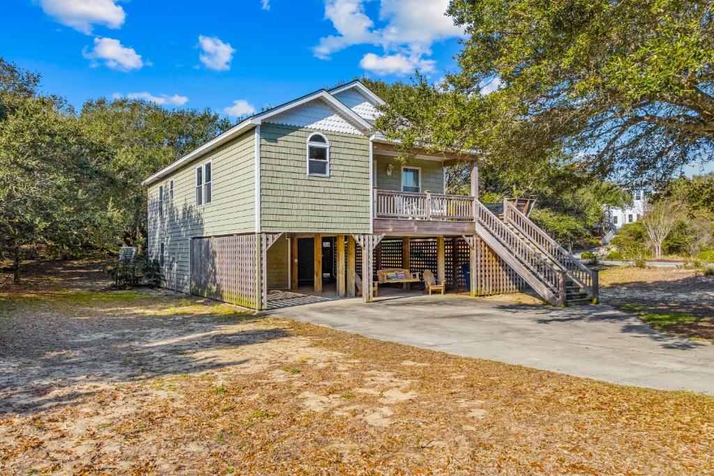 una casa con porche y terraza en The Sandlot, en Southern Shores