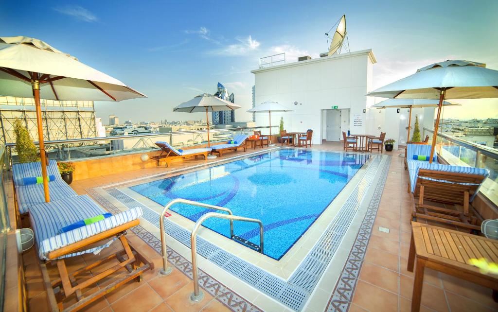 a large swimming pool on top of a building at Raviz Center Point Hotel in Dubai