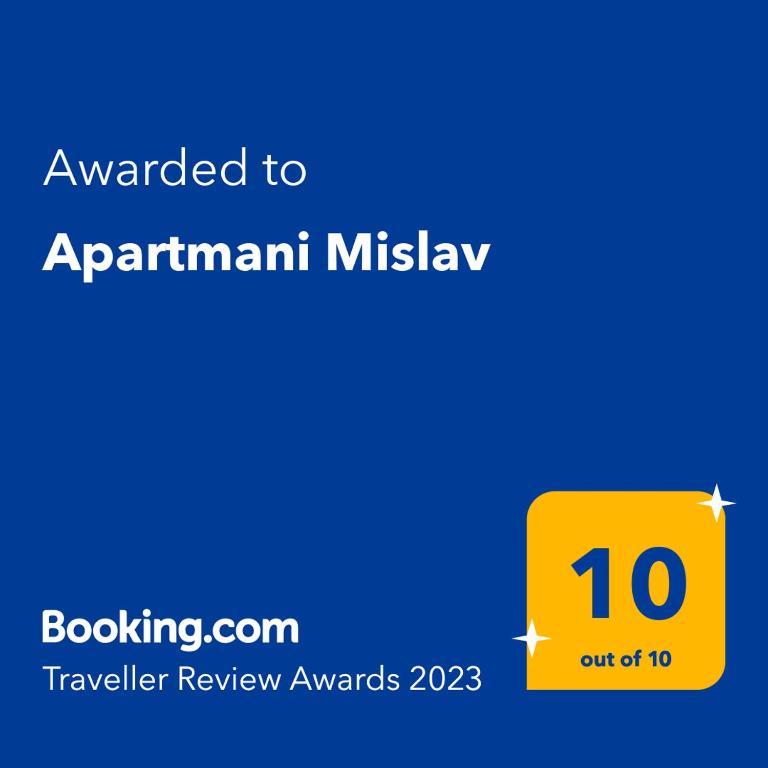 a yellow sign with the text awarded to apartment mistslaw at Apartmani Mislav in Slatine