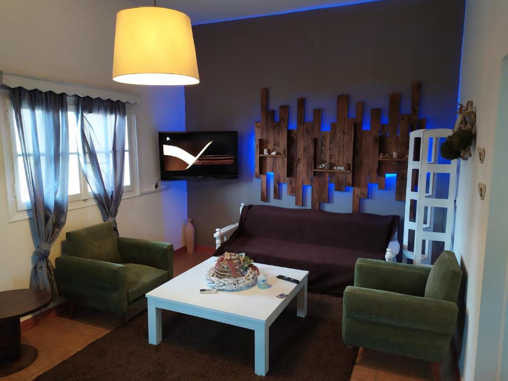 納弗帕克托斯的住宿－Nafpaktos beach Apartment，客厅配有沙发、两把椅子和一张桌子