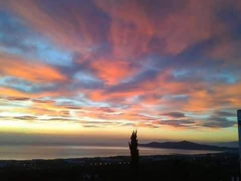a view of a sunset with a cloudy sky at Casa Amanecer Zemzem / Marina Smir in Marina Smir