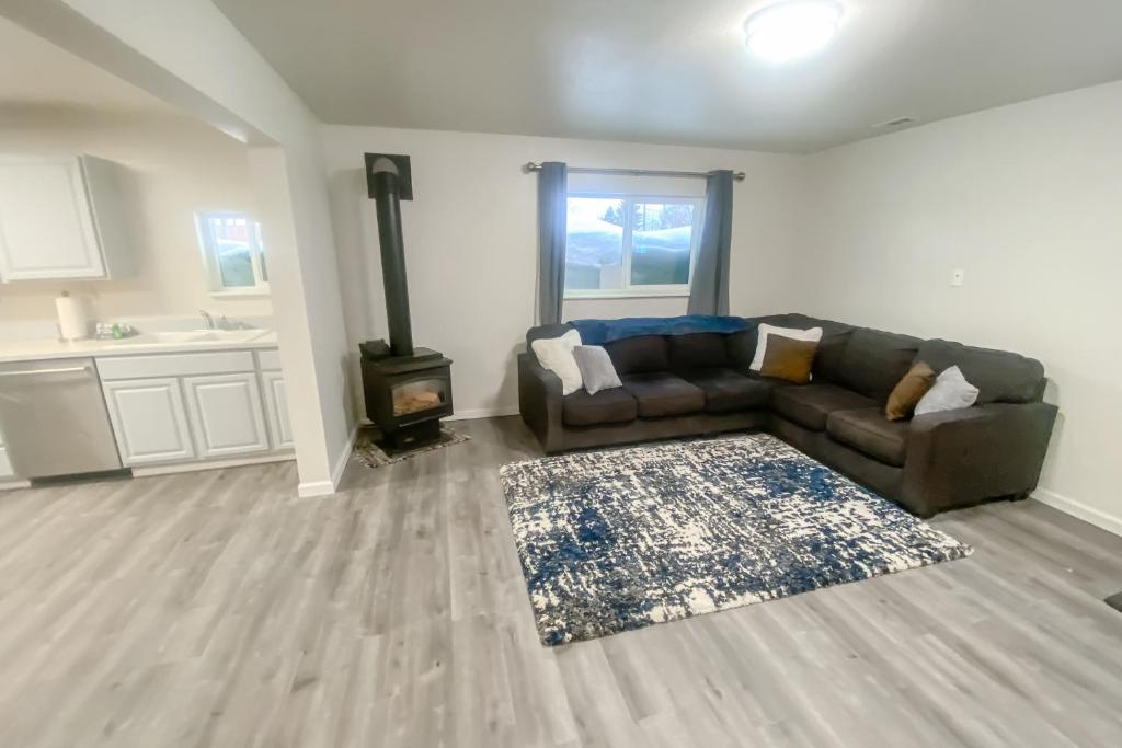 a living room with a couch and a stove at Manor Getaway in Anchorage