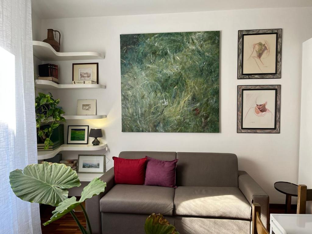 een woonkamer met een bank en een schilderij aan de muur bij Assisi 1461 in Assisi