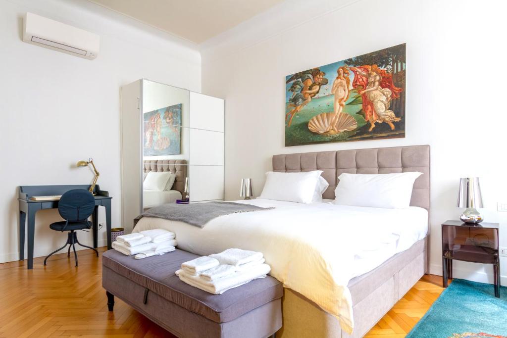 a bedroom with a large bed and a desk at B&B Liberty Suite Milan in Milan