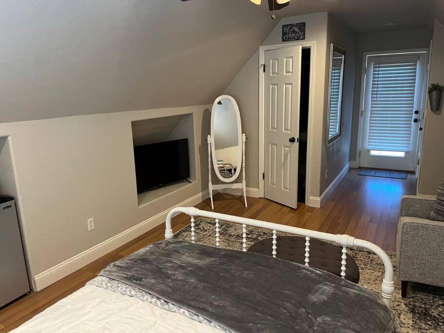 a bedroom with a bed and a mirror and a tv at Adorable 1 Bedroom with pool, and Horse Arena in Oakdale