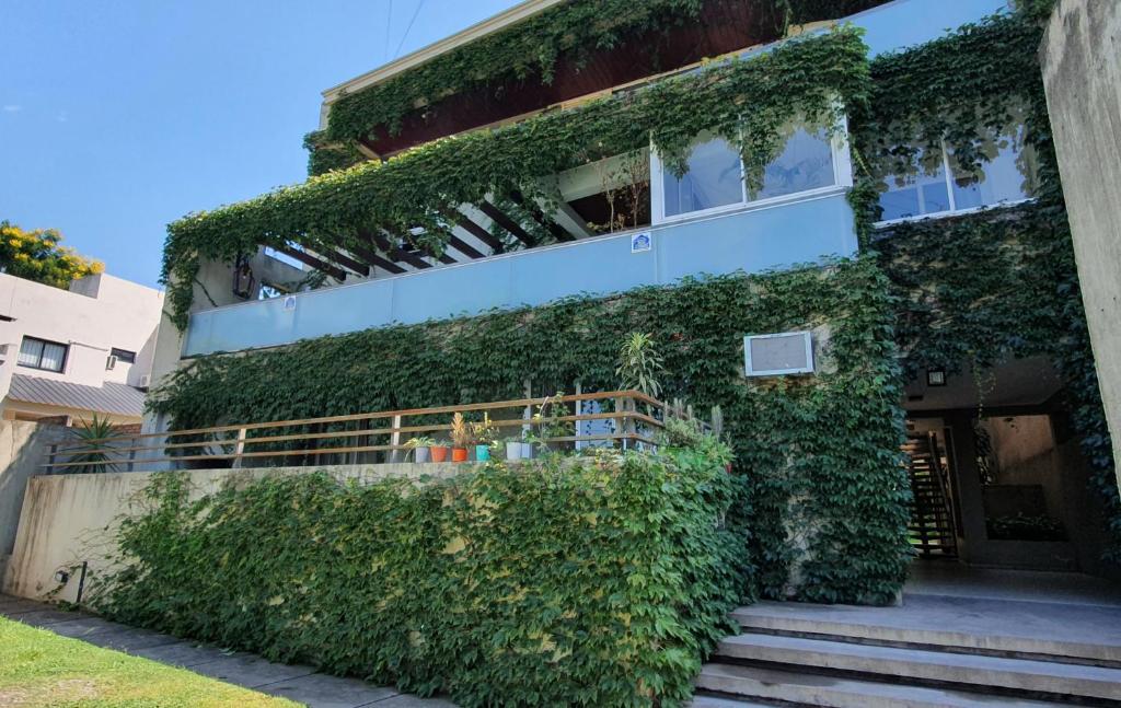 a building covered in green ivy on a street at Beethoven - Bon Repos in Yerba Buena