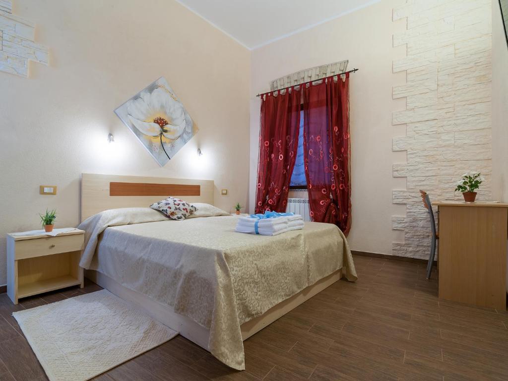 una camera con letto e tenda rossa di Il Borgo a Cagliari