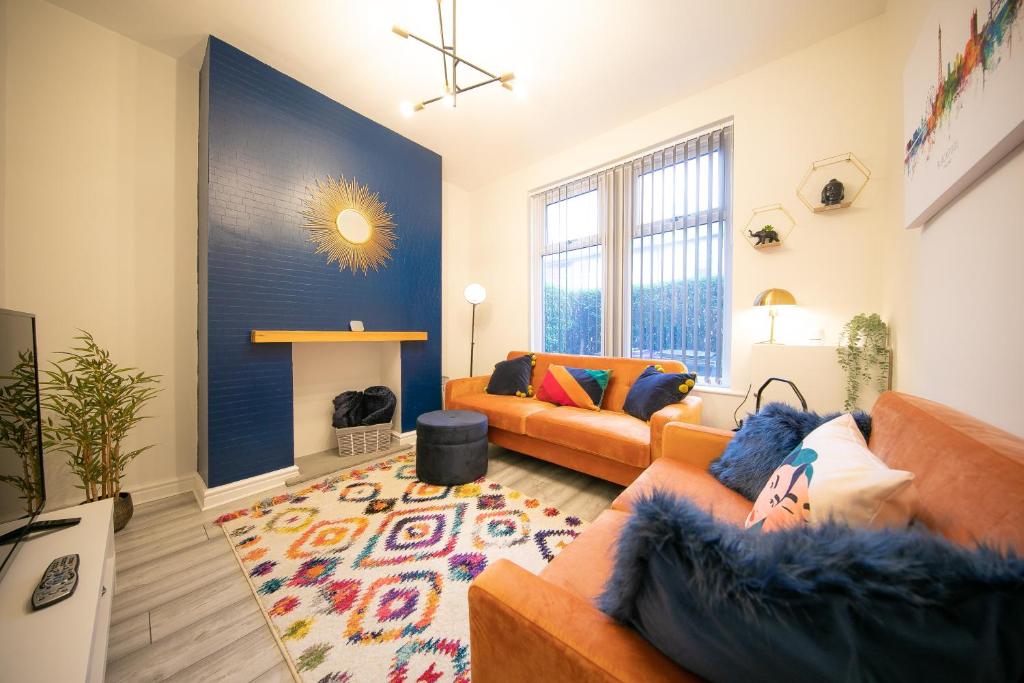 a living room with two couches and a fireplace at Stunning house near Blackpool attractions in Blackpool