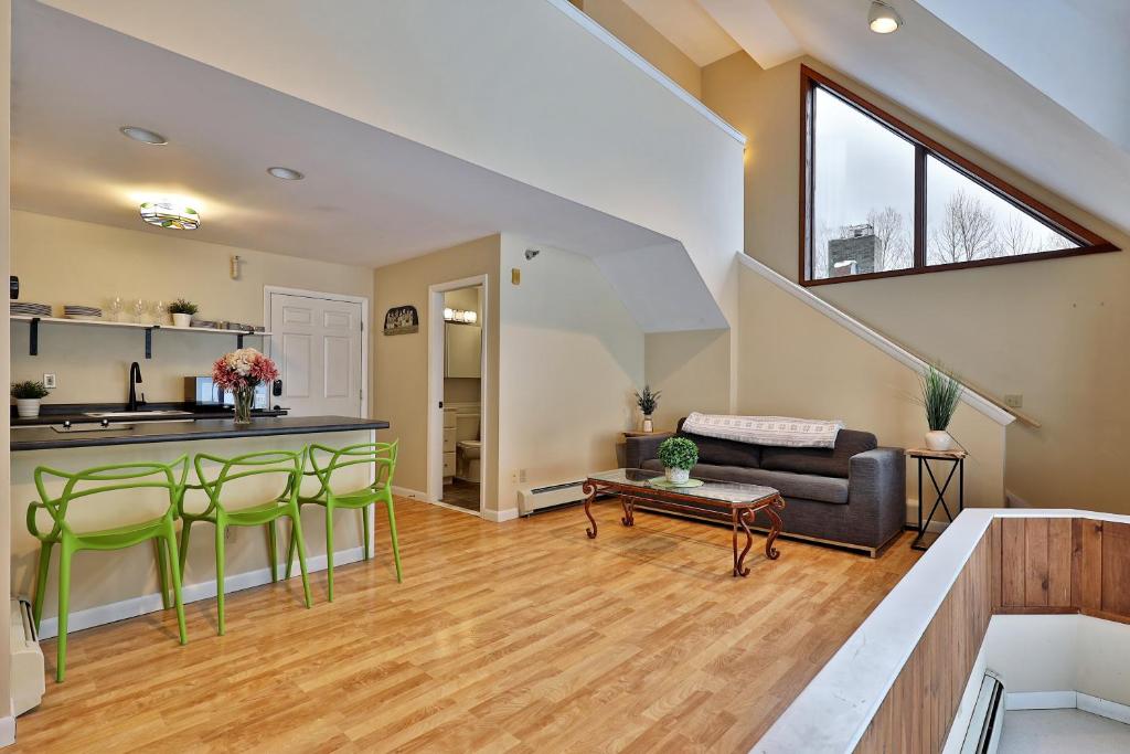 a kitchen and living room with a couch and a table at The Birch Ridge- Owner's Suite #5 - Queen Sofa Bed Suite in Killington, Hot Tub, Renovated, home in Killington