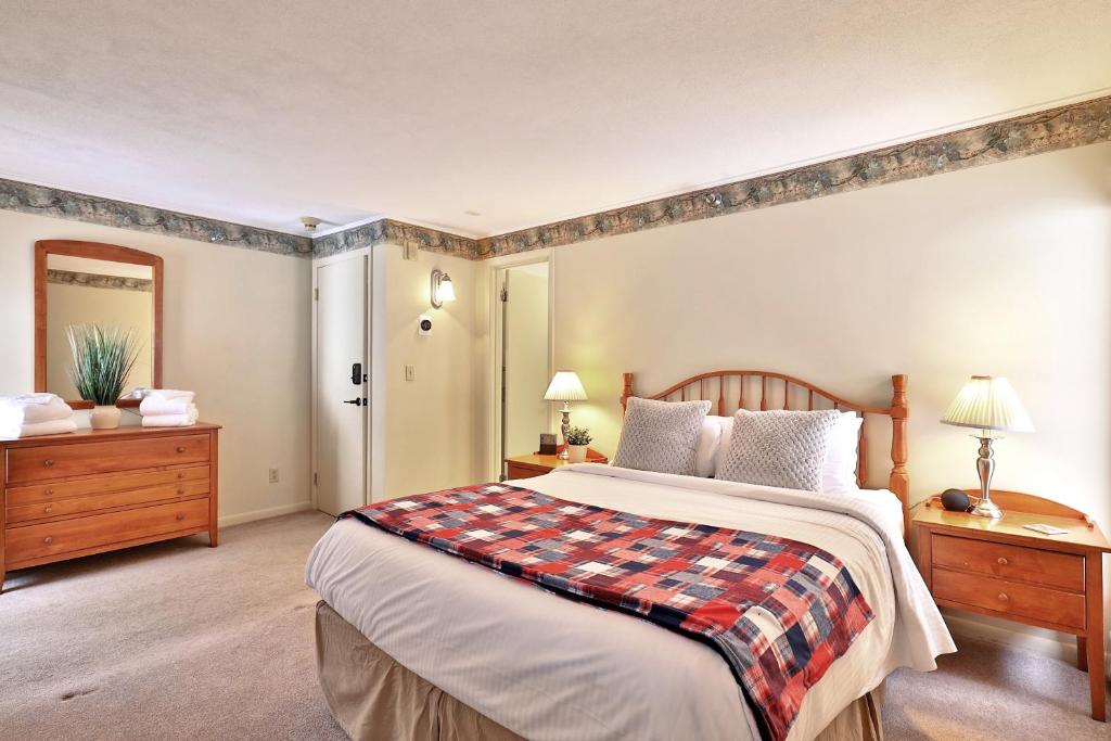 a bedroom with a large bed and two night stands at One-Bedroom House in Killington
