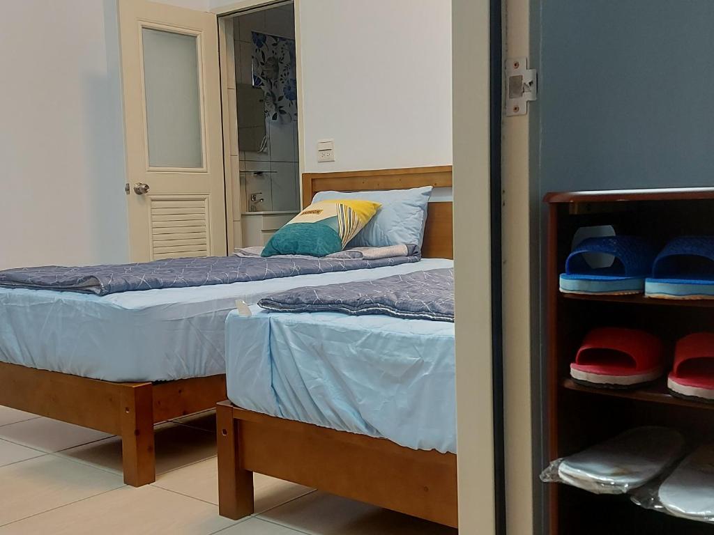 Postel nebo postele na pokoji v ubytování 南田旅宿