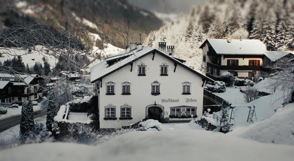 a large white house with snow on the roof at Apartments HAUS SCHÖN - Preise inclusive Pitztal Sommer Card in Jerzens